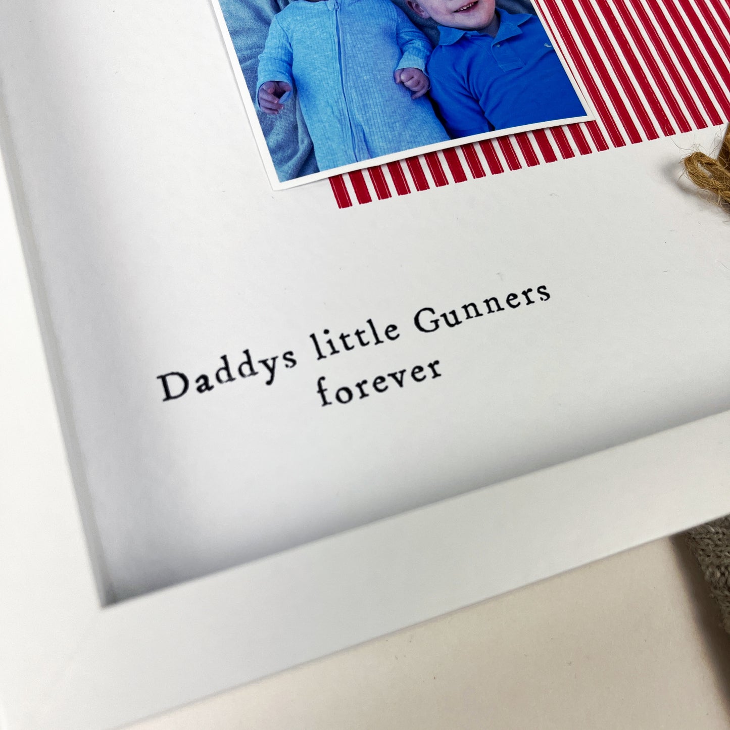 Personalised Arsenal Daddy photo frame gift for Father’s Day, featuring red and white colours, two photo slots, mini pegs, scrabble-style “DADDY” tiles, and message “Daddys little Gunners forever.” Handmade keepsake for football fan dads and Arsenal supporters. Perfect gift from baby or child for a proud Gooner.